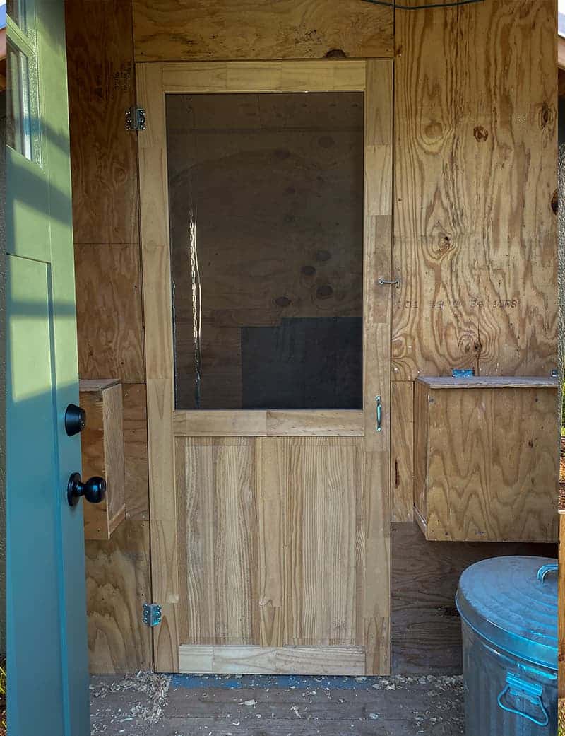 Interior of chicken coop with screen door for seperation