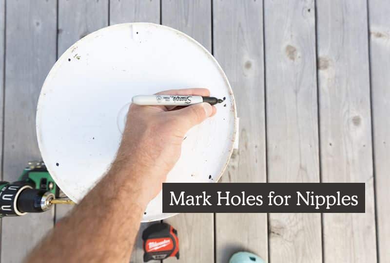 homemade chicken feeder diy - marking holes for nipples