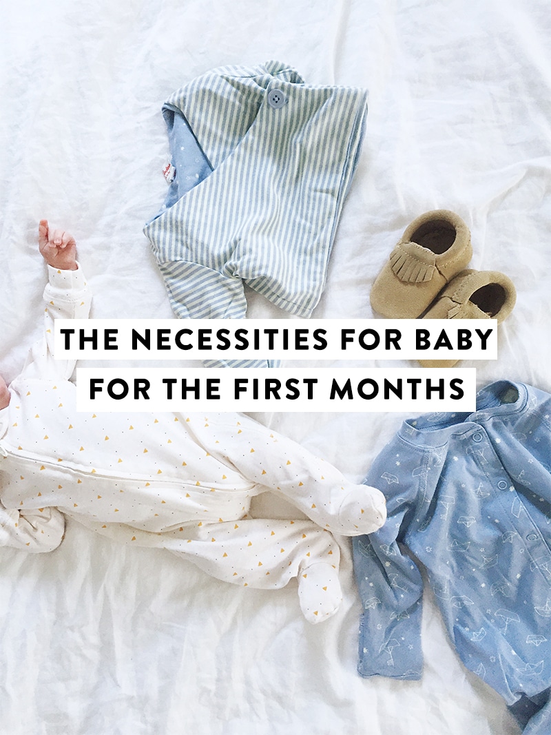 baby with graphic with clothes on bed 