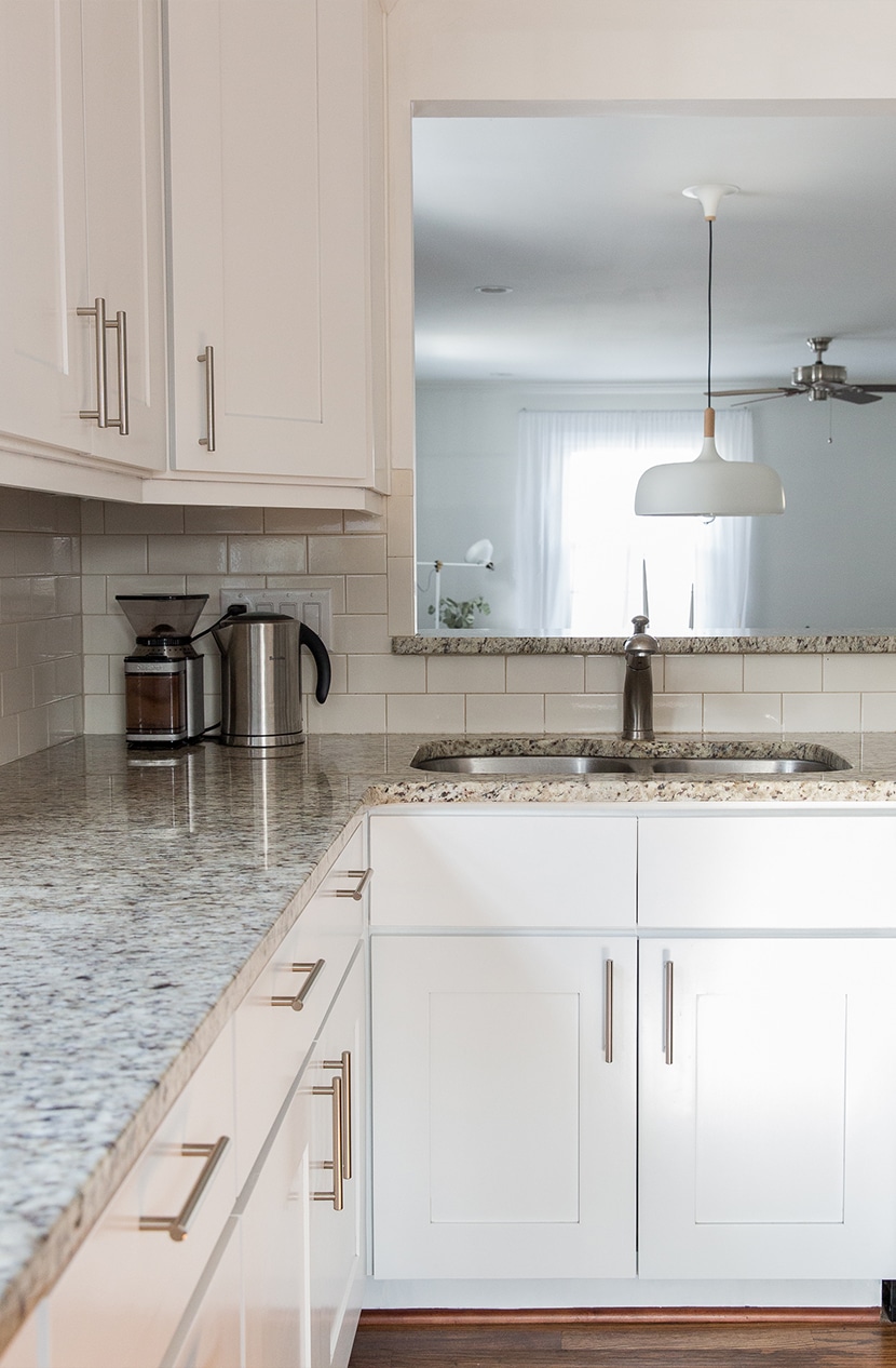 Modern white cabinets with granite countertops