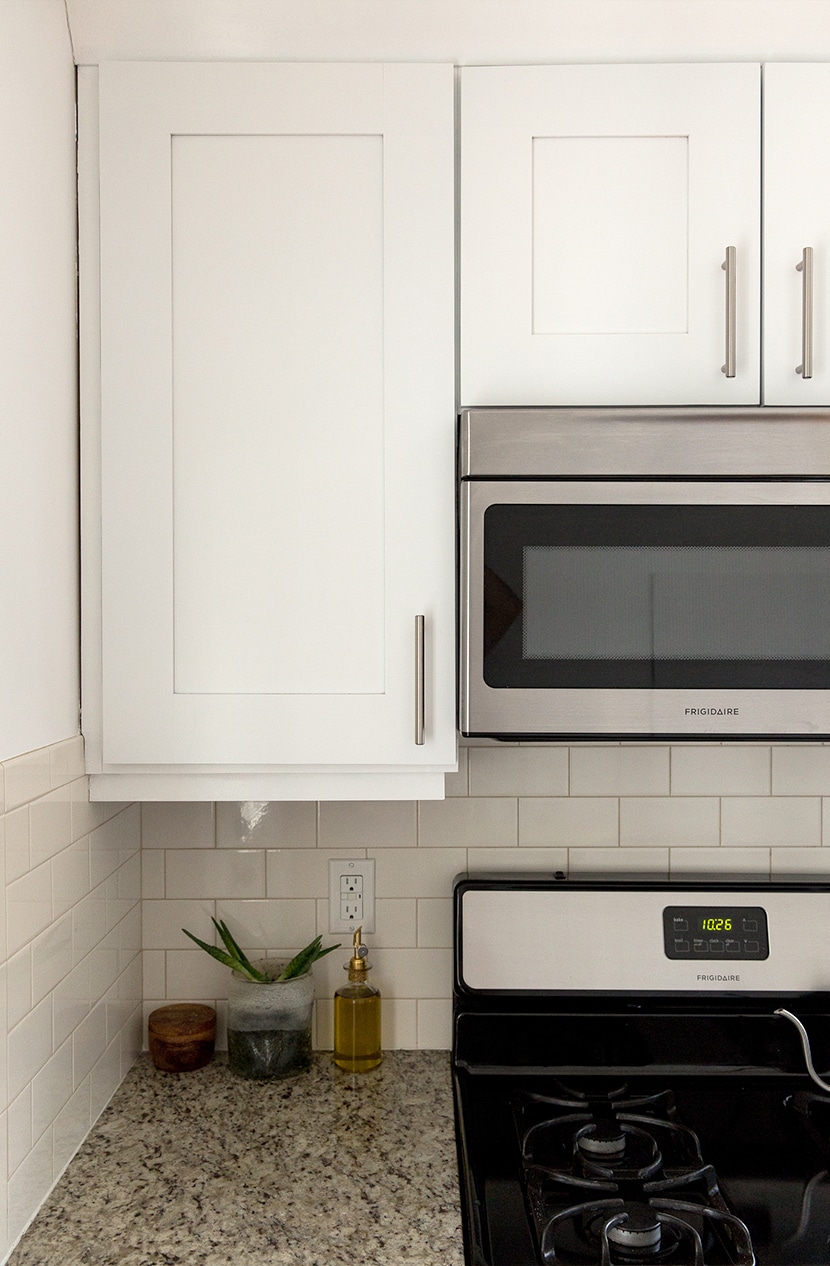 Modern White Kitchen with cream tile and granite counters