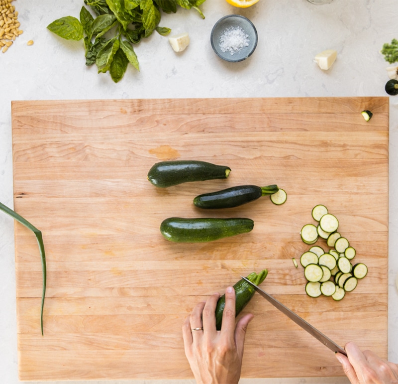 Thinly slicing zucchini to be cooked